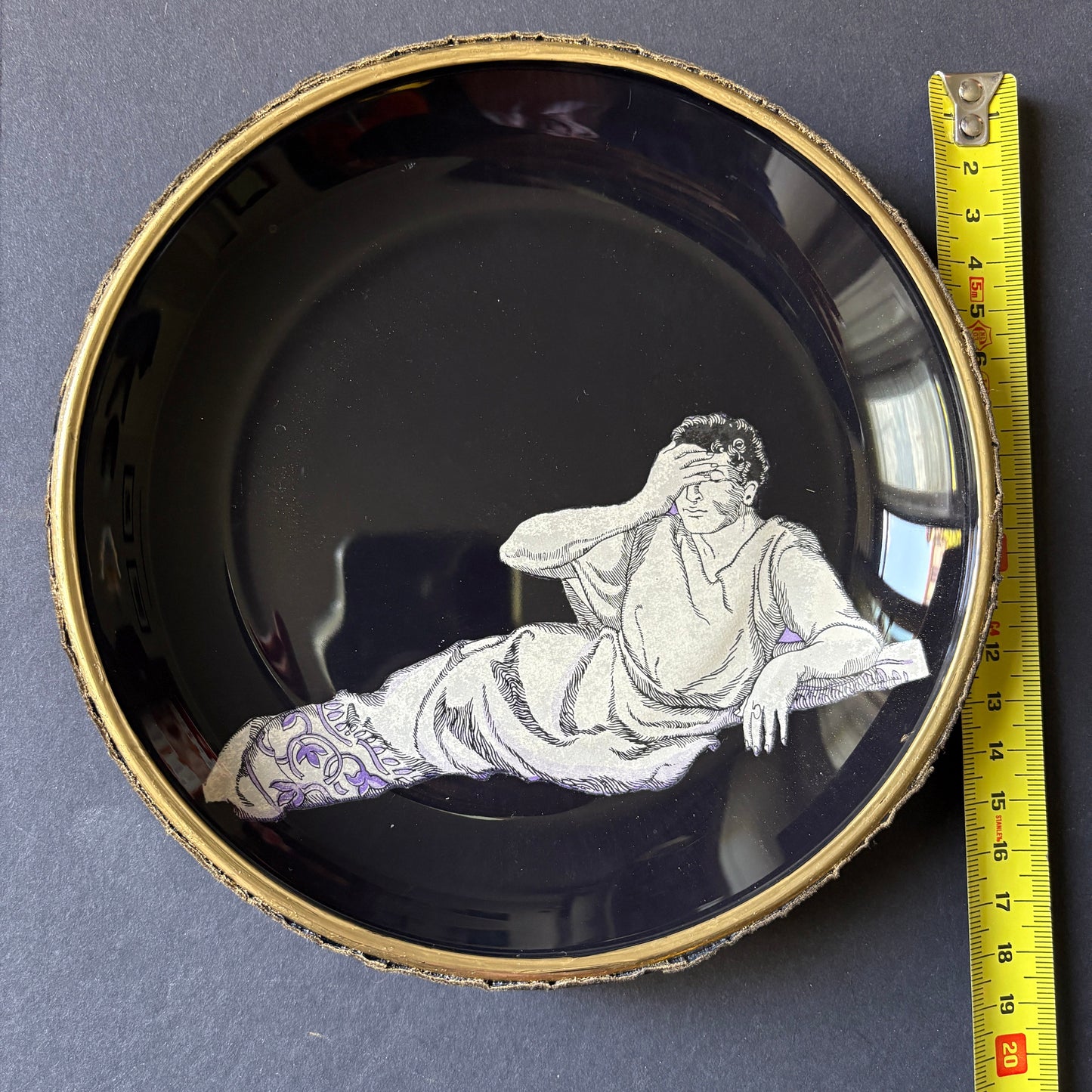 Shelfie: Ancient Roman man leaning on triclinium