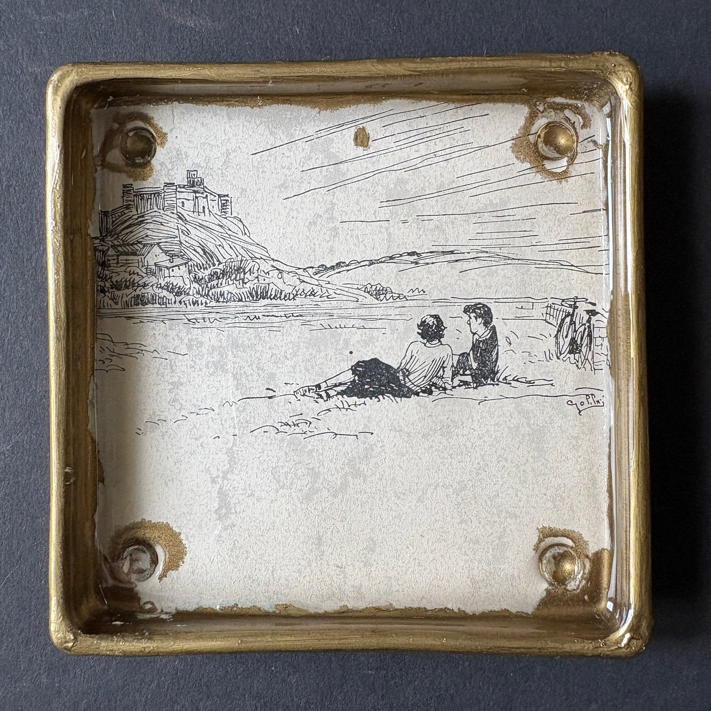 Shelfie: Two boys lying on the grass under the rock