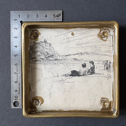 Shelfie: Two boys lying on the grass under the rock